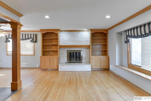 12102 Westover Rd, Omaha, NE 68154 - unfurnished living room featuring ornate columns, light wood-style floors, crown molding, ceiling fan, and a fireplace