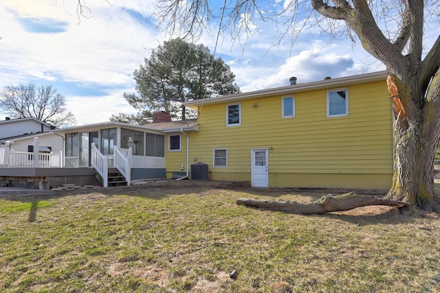 12102 Westover Rd, Omaha, NE 68154 - back of property with a sunroom, a yard, a chimney, and a wooden deck