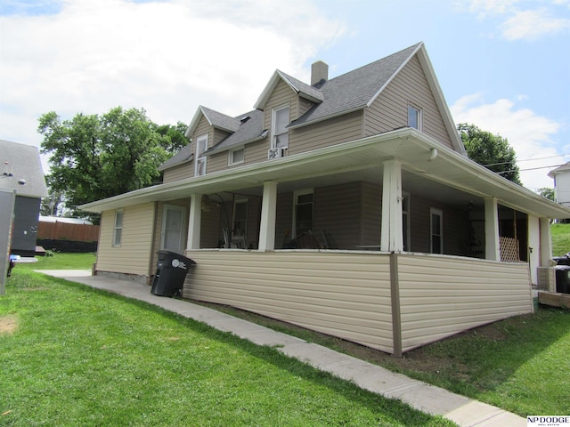 2711 Shirley St, Omaha, NE 68105 - view of side of property featuring a yard, roof with shingles, and a chimney