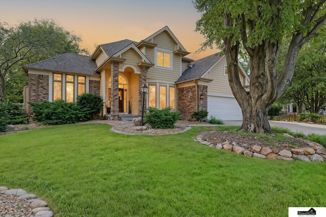 5807 S 167th Ave, Omaha, NE 68135 - view of front facade featuring a front lawn, concrete driveway, an attached garage, and stone siding
