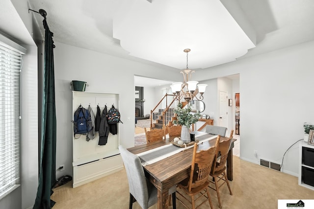 5807 S 167th Ave, Omaha, NE 68135 - dining room with light colored carpet and a chandelier