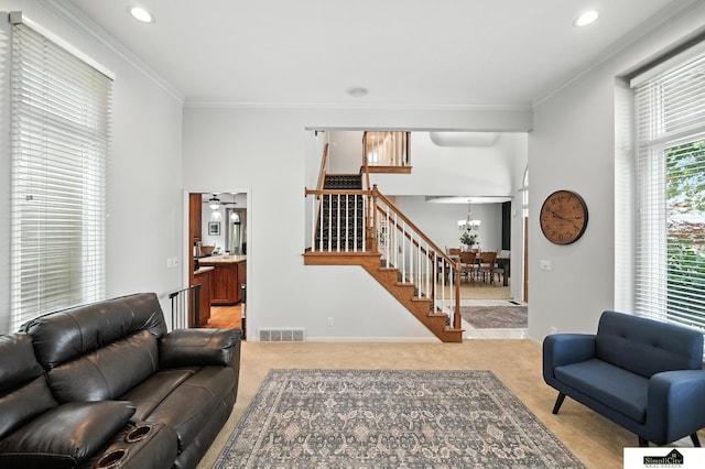 5807 S 167th Ave, Omaha, NE 68135 - carpeted living room featuring stairway, a chandelier, ornamental molding, and recessed lighting