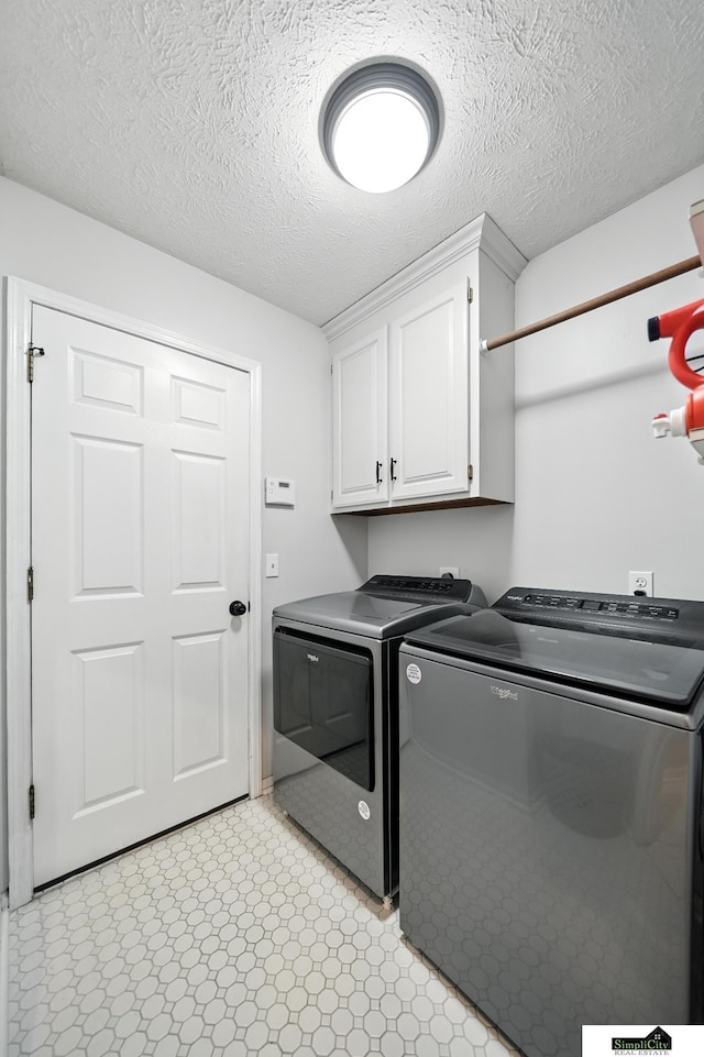 5807 S 167th Ave, Omaha, NE 68135 - laundry area featuring independent washer and dryer, cabinet space, and a textured ceiling