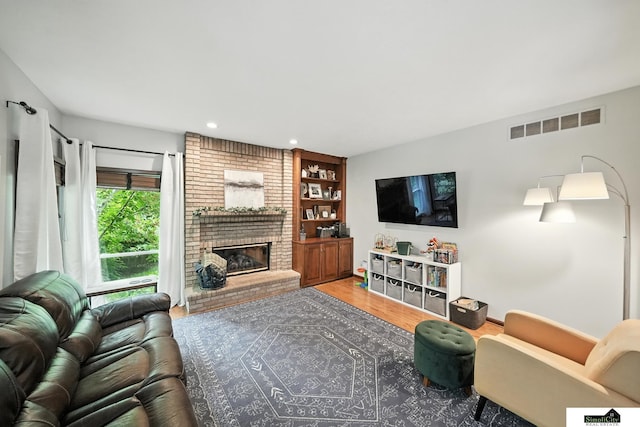 5807 S 167th Ave, Omaha, NE 68135 - living area featuring a brick fireplace, wood finished floors, recessed lighting, and built in shelves