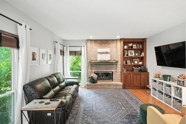 5807 S 167th Ave, Omaha, NE 68135 - living area featuring wood finished floors, a brick fireplace, and recessed lighting