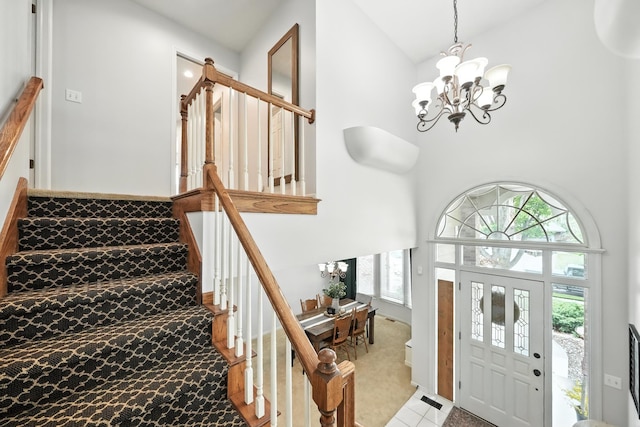 5807 S 167th Ave, Omaha, NE 68135 - carpeted foyer featuring a chandelier, stairway, plenty of natural light, and a high ceiling