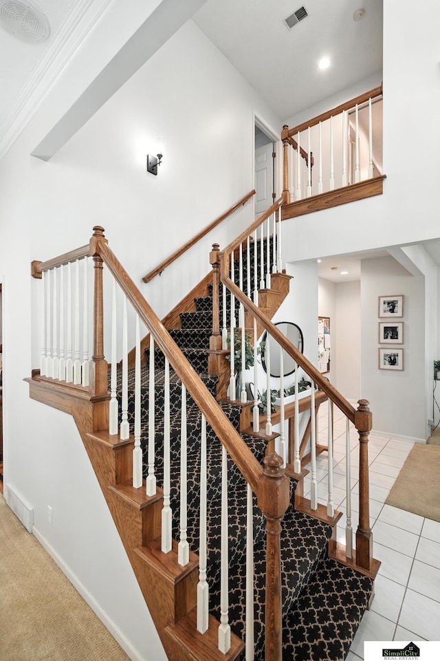 5807 S 167th Ave, Omaha, NE 68135 - stairs featuring tile patterned flooring, ornamental molding, and a towering ceiling