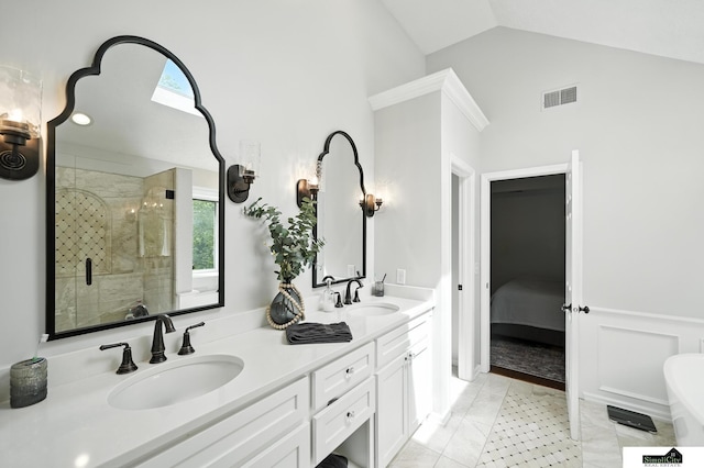 5807 S 167th Ave, Omaha, NE 68135 - ensuite bathroom featuring a stall shower, double vanity, lofted ceiling, plenty of natural light, and a freestanding tub