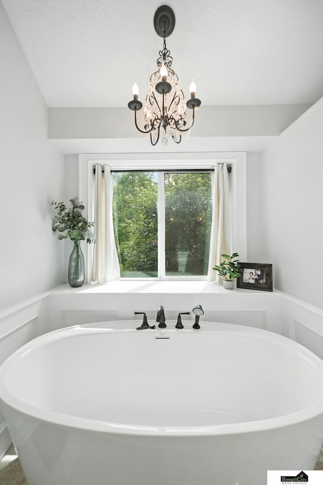 5807 S 167th Ave, Omaha, NE 68135 - bathroom featuring a soaking tub and a chandelier