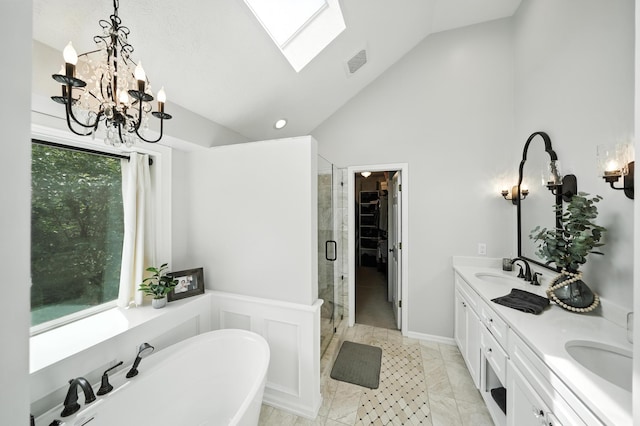 5807 S 167th Ave, Omaha, NE 68135 - bathroom with a soaking tub, a shower stall, double vanity, a chandelier, and a walk in closet