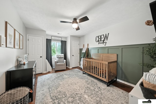 5807 S 167th Ave, Omaha, NE 68135 - bedroom with wood finished floors, a nursery area, and ceiling fan