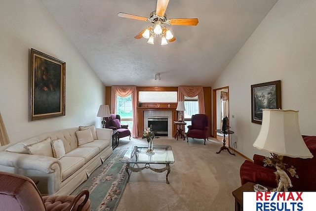 17315 M St, Omaha, NE 68135 - living room with lofted ceiling, carpet, ceiling fan, and a tiled fireplace