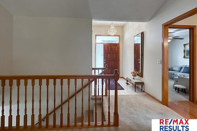 17315 M St, Omaha, NE 68135 - foyer entrance featuring light colored carpet and a chandelier