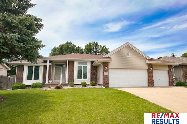 17315 M St, Omaha, NE 68135 - view of front of home featuring an attached garage, concrete driveway, and brick siding