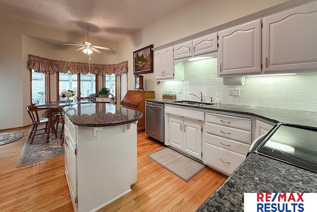 17315 M St, Omaha, NE 68135 - kitchen featuring stainless steel dishwasher, a center island, light wood-style floors, a ceiling fan, and lofted ceiling
