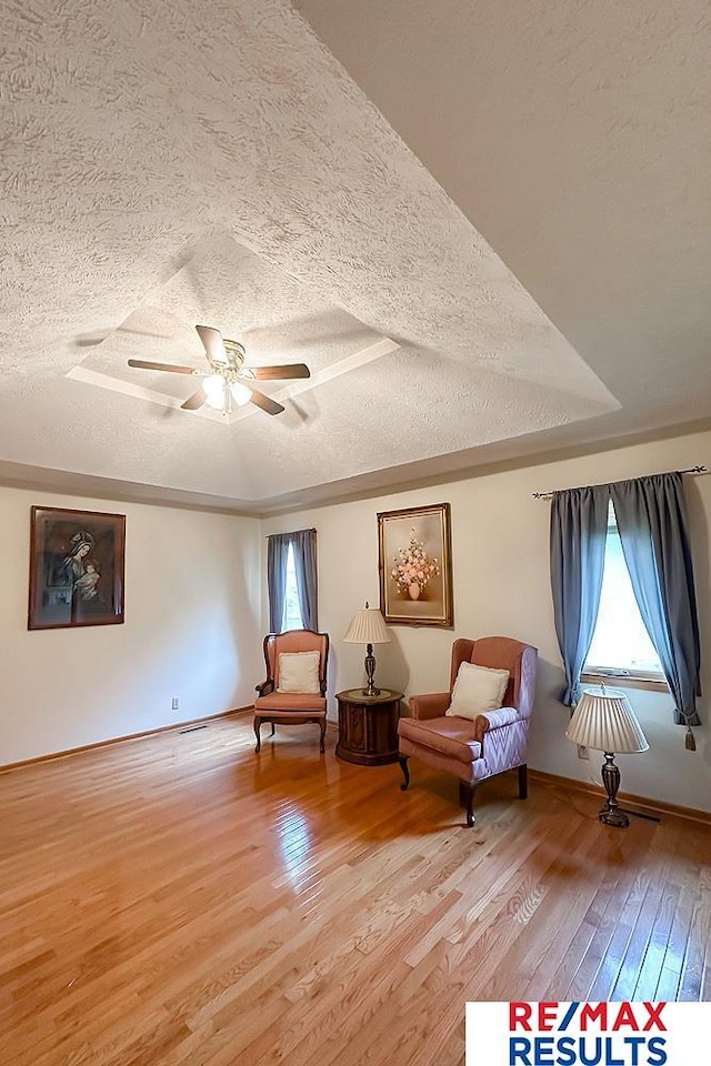 17315 M St, Omaha, NE 68135 - sitting room with a textured ceiling, healthy amount of natural light, light wood-type flooring, and a ceiling fan