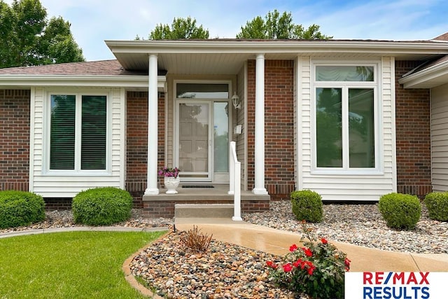 17315 M St, Omaha, NE 68135 - doorway to property featuring brick siding and covered porch