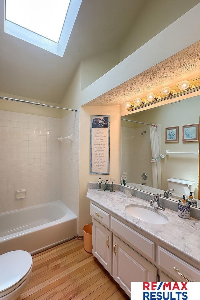 17315 M St, Omaha, NE 68135 - bathroom with shower / bath combo, vanity, a skylight, wood finished floors, and vaulted ceiling