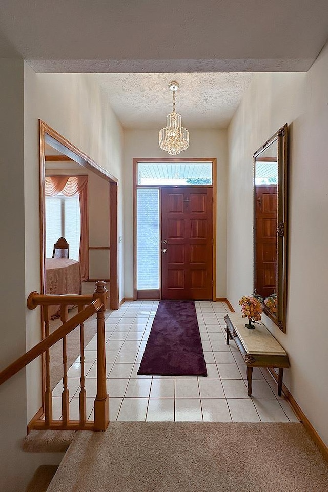 17315 M St, Omaha, NE 68135 - foyer featuring a textured ceiling, healthy amount of natural light, a chandelier, and light tile patterned flooring