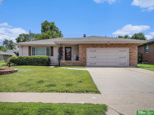 4015 Arbor St, Omaha, NE 68105 - ranch-style house featuring a garage, a front yard, concrete driveway, and brick siding