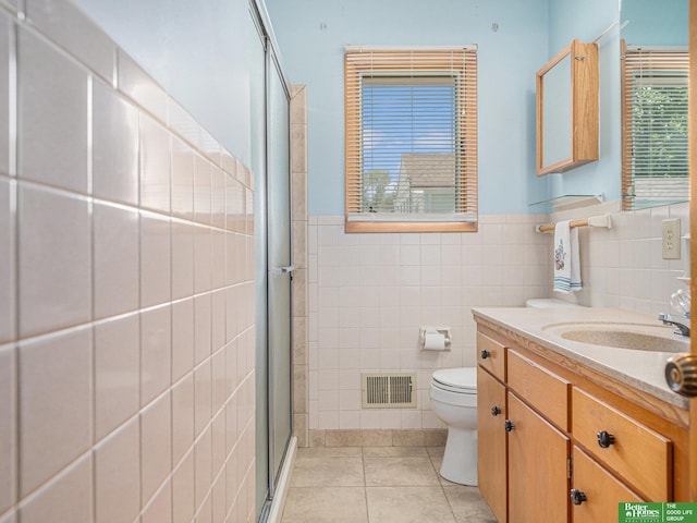 4015 Arbor St, Omaha, NE 68105 - bathroom featuring tile walls, tile patterned flooring, a shower stall, vanity, and wainscoting