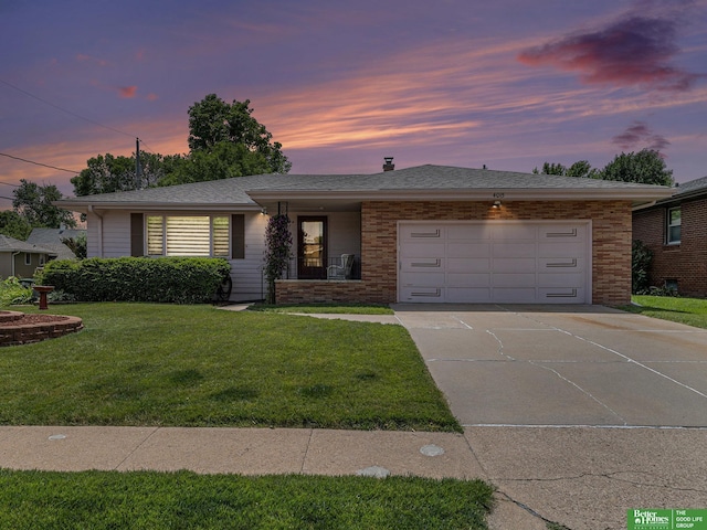 4015 Arbor St, Omaha, NE 68105 - ranch-style house featuring a garage, driveway, a front lawn, and brick siding