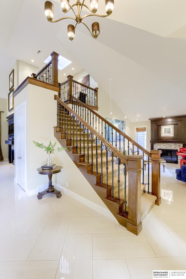 310 S 89th Ct, Omaha, NE 68114 - staircase with a glass covered fireplace, a chandelier, and tile patterned flooring