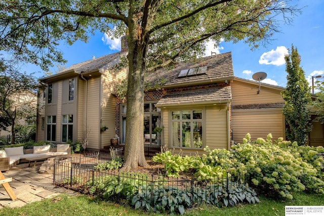 310 S 89th Ct, Omaha, NE 68114 - rear view of property featuring a patio, a chimney, and an outdoor living space