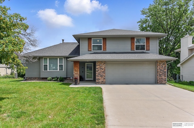 935 S 150th St, Omaha, NE 68154 - view of front of home featuring concrete driveway, a garage, a front lawn, and a shingled roof
