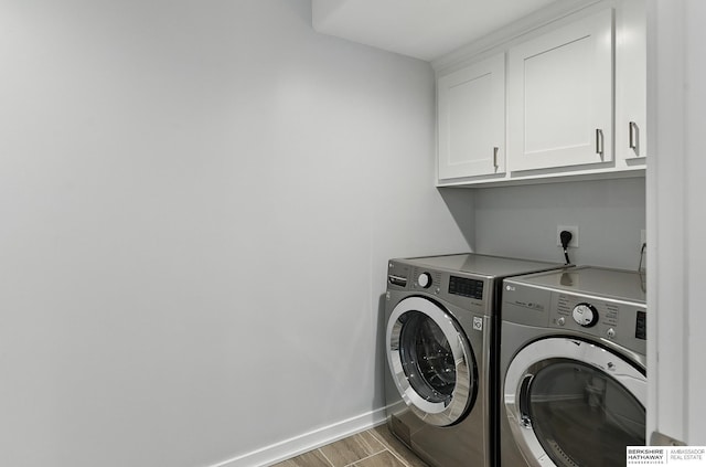 935 S 150th St, Omaha, NE 68154 - laundry room with cabinet space, separate washer and dryer, and wood finished floors