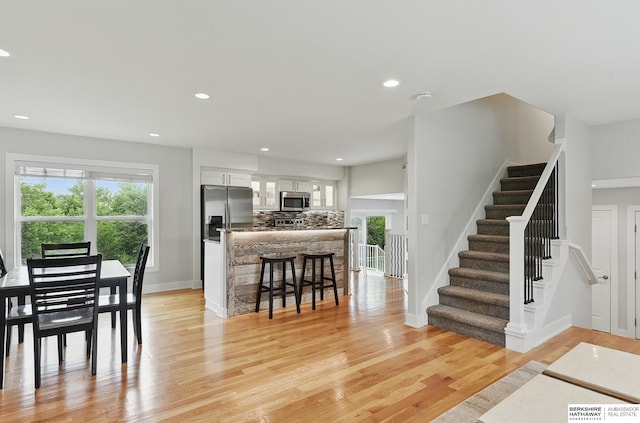 935 S 150th St, Omaha, NE 68154 - dining area featuring plenty of natural light, stairs, light wood-type flooring, and recessed lighting