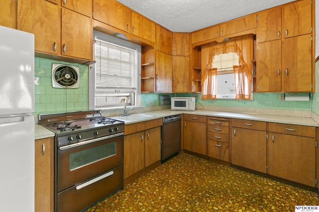 602 N 85th St, Omaha, NE 68114 - kitchen with white appliances, healthy amount of natural light, tasteful backsplash, and a textured ceiling