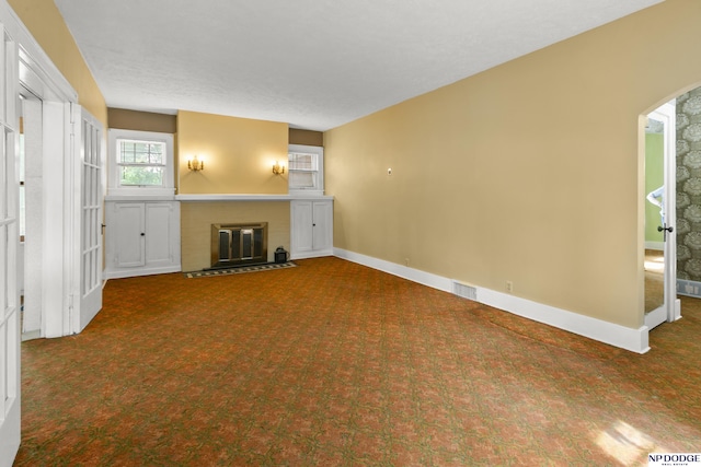 602 N 85th St, Omaha, NE 68114 - unfurnished living room featuring carpet floors, a brick fireplace, and arched walkways