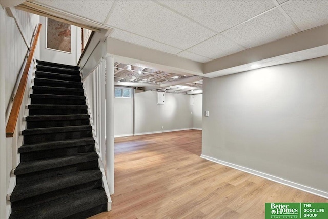 454 N 61st St, Omaha, NE 68132 - below grade area with stairs, light wood-type flooring, and a paneled ceiling