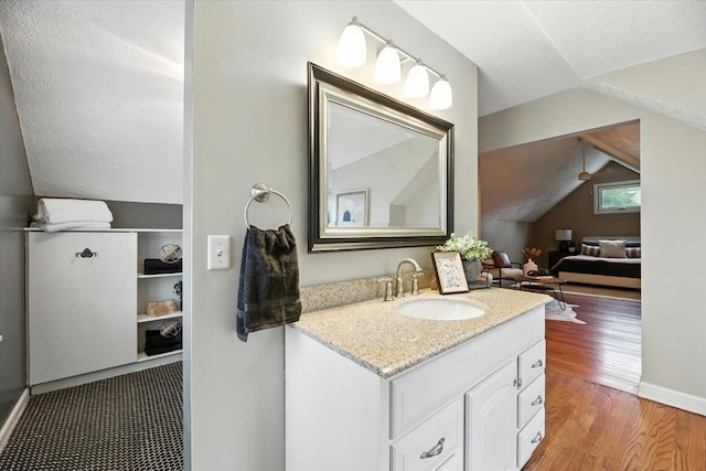 454 N 61st St, Omaha, NE 68132 - bathroom featuring vanity, wood finished floors, and lofted ceiling