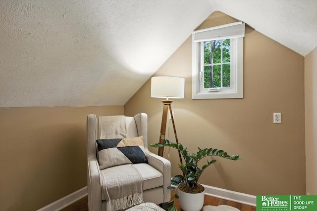 454 N 61st St, Omaha, NE 68132 - sitting room featuring a textured ceiling, lofted ceiling, and wood finished floors
