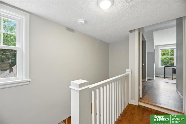 454 N 61st St, Omaha, NE 68132 - hall featuring an upstairs landing, wood finished floors, and a textured ceiling