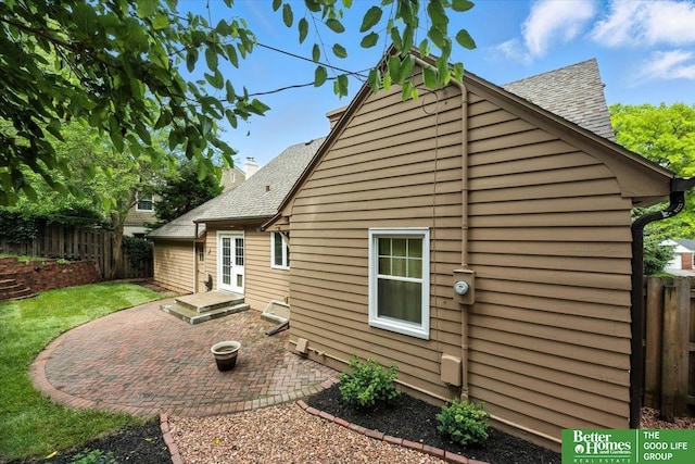 454 N 61st St, Omaha, NE 68132 - rear view of house featuring a patio, roof with shingles, and entry steps