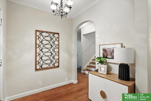 454 N 61st St, Omaha, NE 68132 - hallway featuring ornamental molding, arched walkways, wood finished floors, stairway, and a chandelier