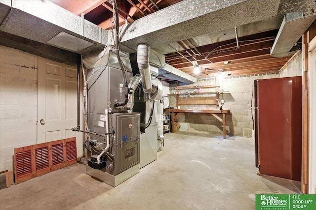 454 N 61st St, Omaha, NE 68132 - unfinished basement featuring freestanding refrigerator, concrete block wall, and heating unit