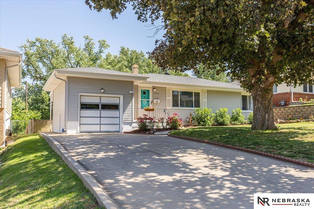 4424 Frederick St, Omaha, NE 68105 - ranch-style house featuring a garage, driveway, and a chimney