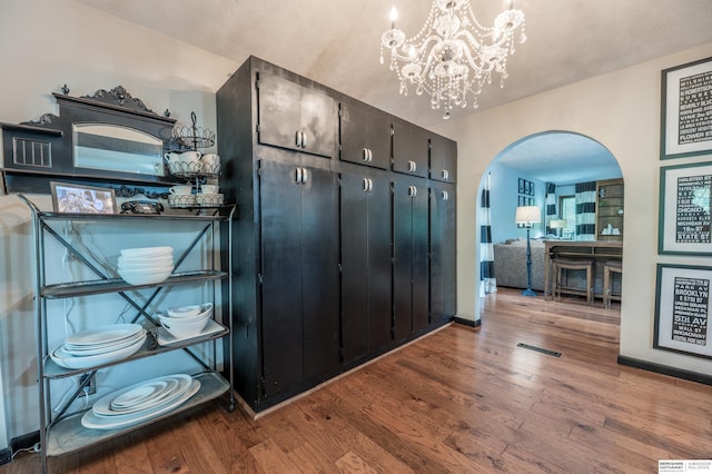 2105 S 164th Ave, Omaha, NE 68130 - mudroom featuring arched walkways, wood finished floors, and a chandelier
