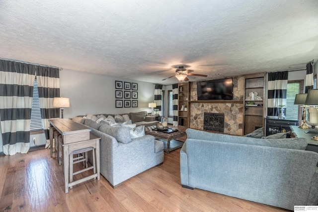 2105 S 164th Ave, Omaha, NE 68130 - living area with ceiling fan, a textured ceiling, wood finished floors, and a fireplace