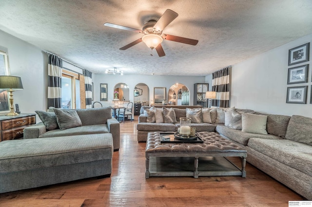 2105 S 164th Ave, Omaha, NE 68130 - living area with arched walkways, a textured ceiling, a ceiling fan, and hardwood / wood-style floors