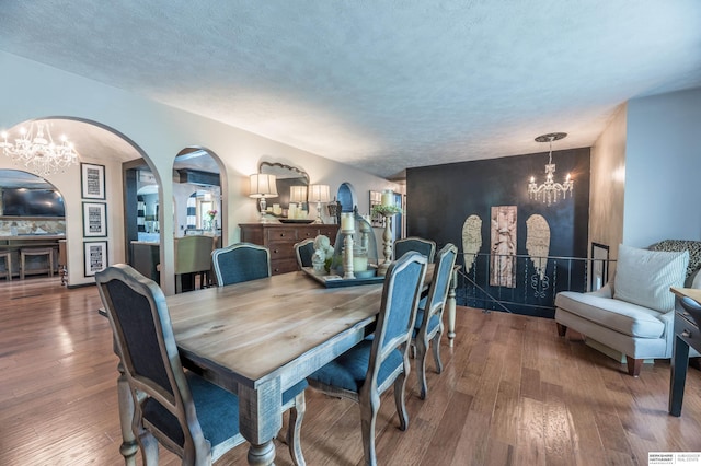 2105 S 164th Ave, Omaha, NE 68130 - dining room with a chandelier, arched walkways, and wood finished floors