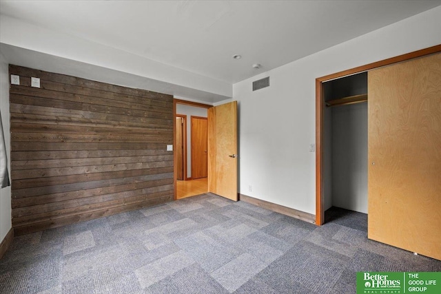 5510 N 83rd St, Omaha, NE 68134 - unfurnished bedroom with carpet, a closet, and wooden walls