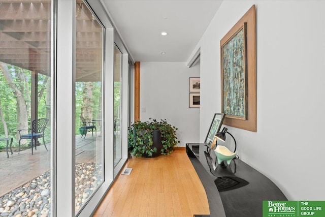 5510 N 83rd St, Omaha, NE 68134 - hallway featuring expansive windows, wood finished floors, and recessed lighting