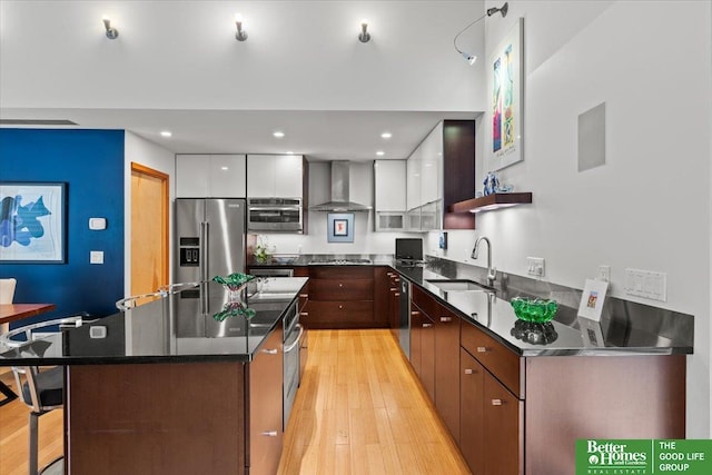 5510 N 83rd St, Omaha, NE 68134 - kitchen featuring appliances with stainless steel finishes, wall chimney exhaust hood, light wood-style flooring, modern cabinets, and recessed lighting