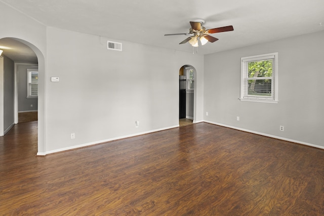 402 W 30th Ave, Bellevue, NE 68005 - spare room featuring arched walkways, ceiling fan, and dark wood-style floors