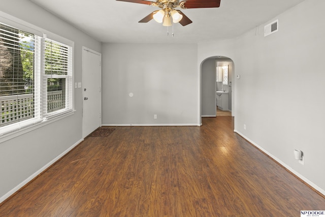 402 W 30th Ave, Bellevue, NE 68005 - empty room featuring arched walkways, a ceiling fan, and wood finished floors